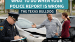 Houston police officer writing an accident report while drivers dispute details — Texas Bulldog Law Firm.