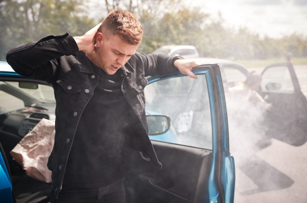 Injured driver making a phone call after a car accident