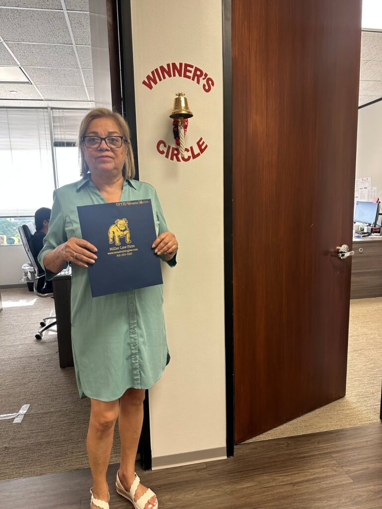 Houston client celebrates their case win at The Miller Law Firm office.