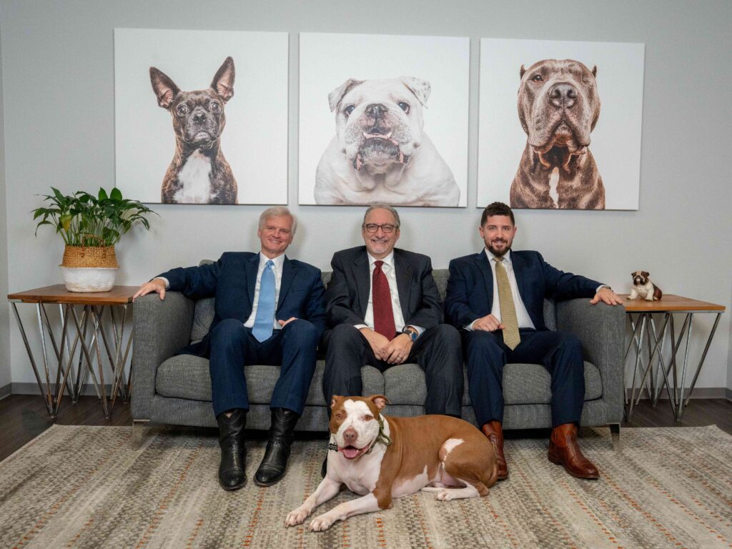 Houston personal injury attorneys Adam H. Miller, Daniel Weisfeld, and Drew Shirley with McLovin at The Miller Law Firm office.